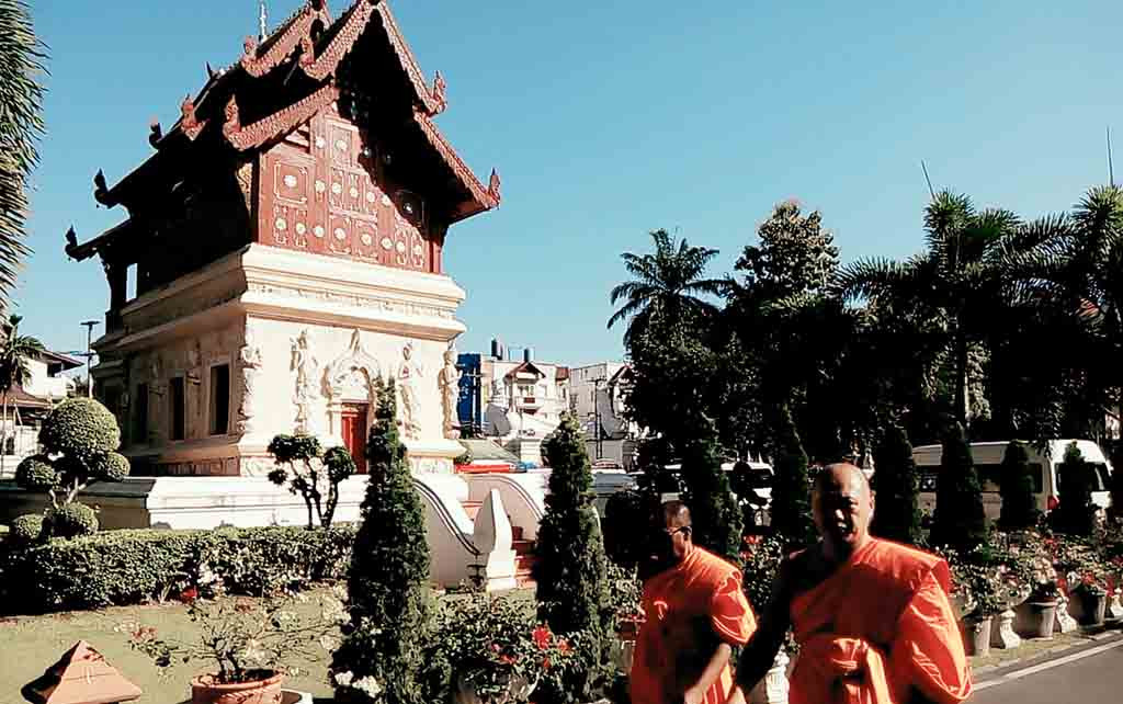 chiang mai, wat phra singh - monks in garden